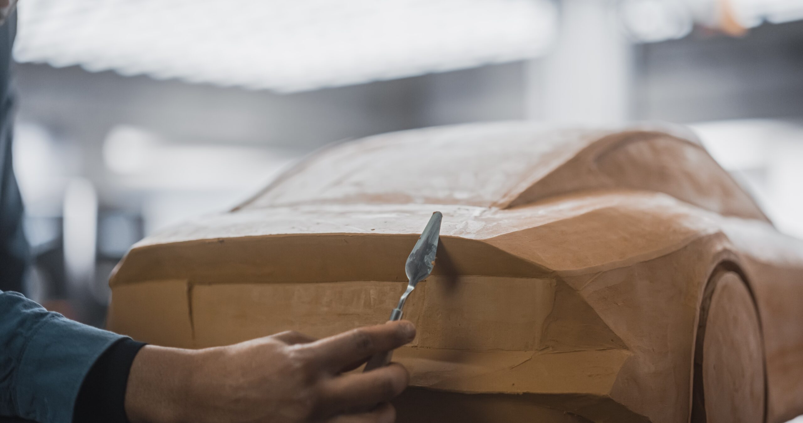 Close up clay model with automotive designer