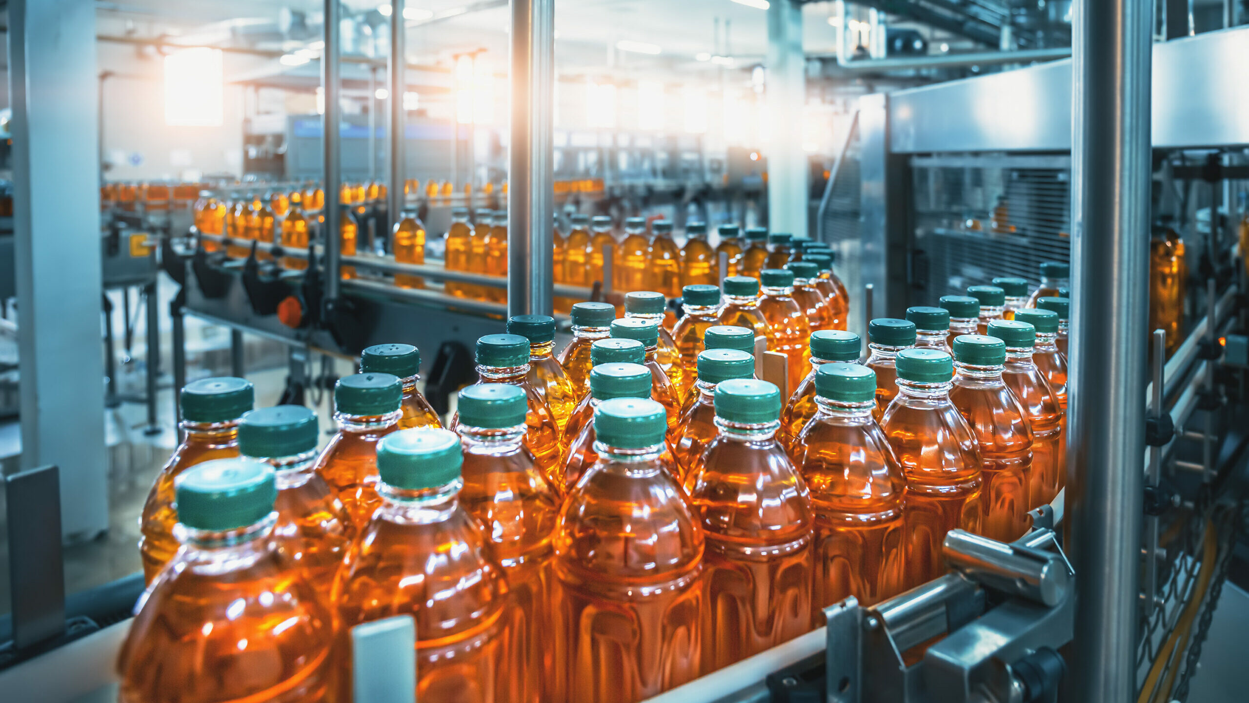 FMCG recruitment for Jonathan Lee Recruitment with juice bottles on a production line