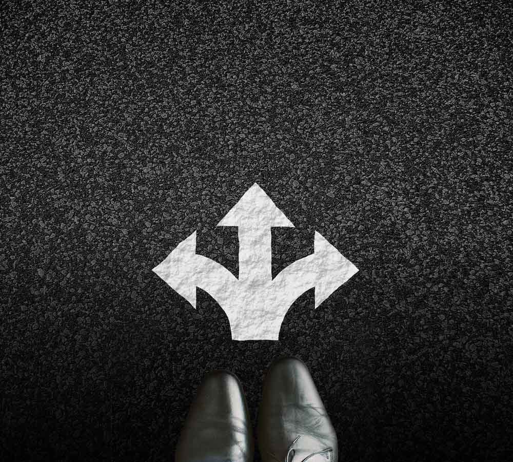 Image of two feet and infront three white arrows on a black background