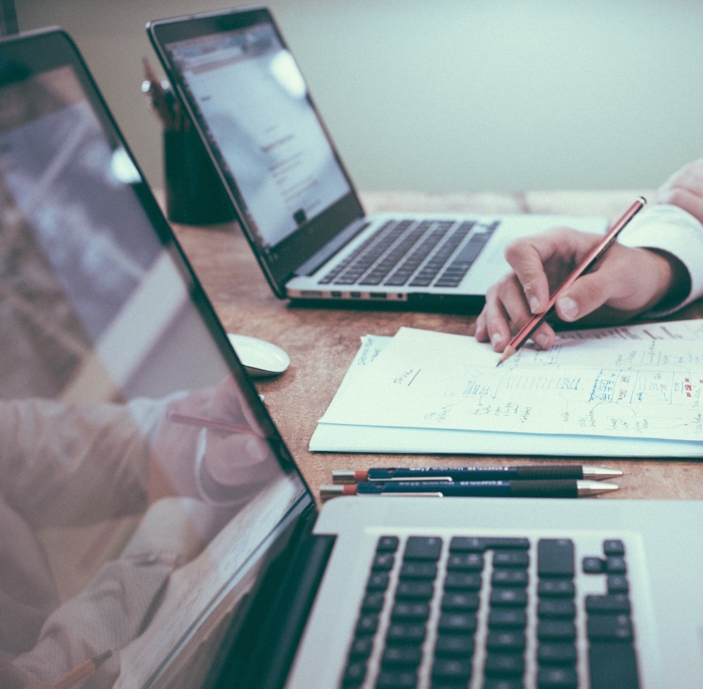 Image of laptops and written work