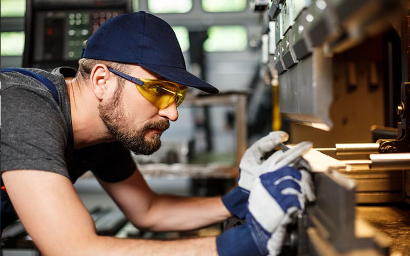 man using a metal machine