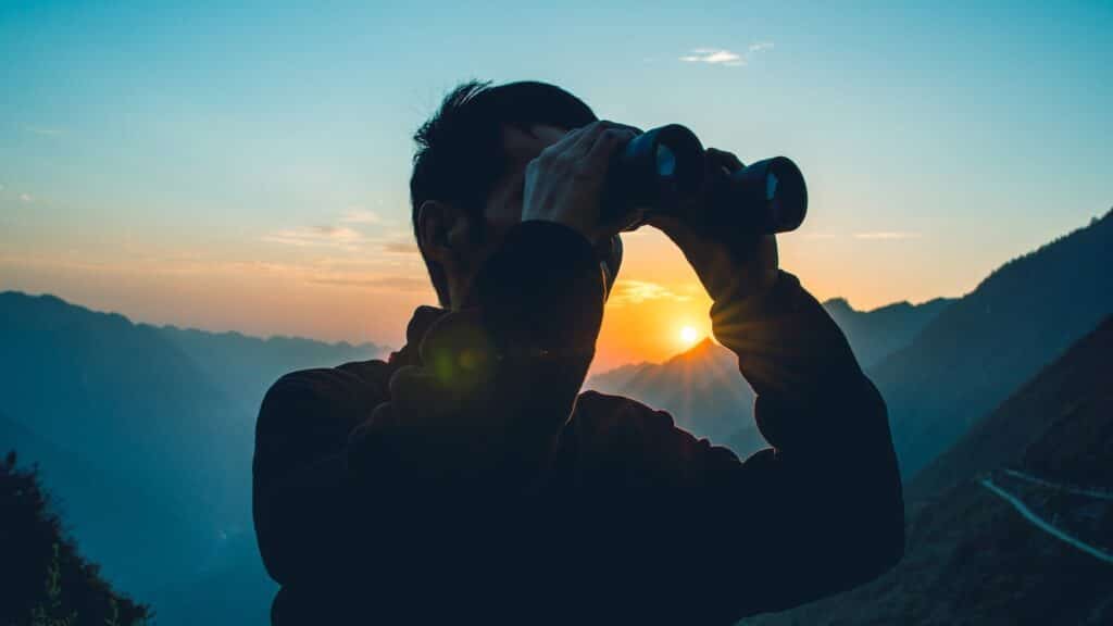 Man looking through binoculars