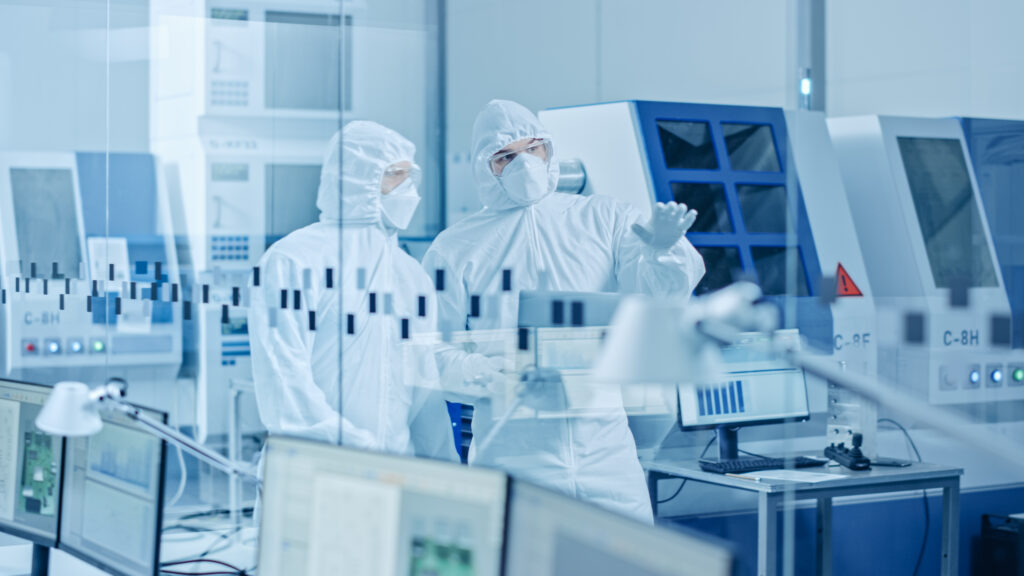 Image of two men in hazmat suits in a laboratory for health and safety