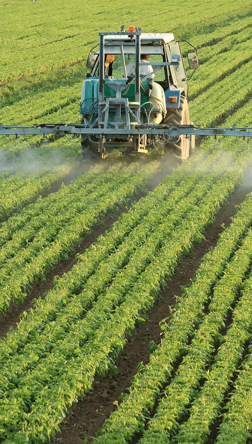 Agriculture recruitment sector image of a tractor in field spraying crops