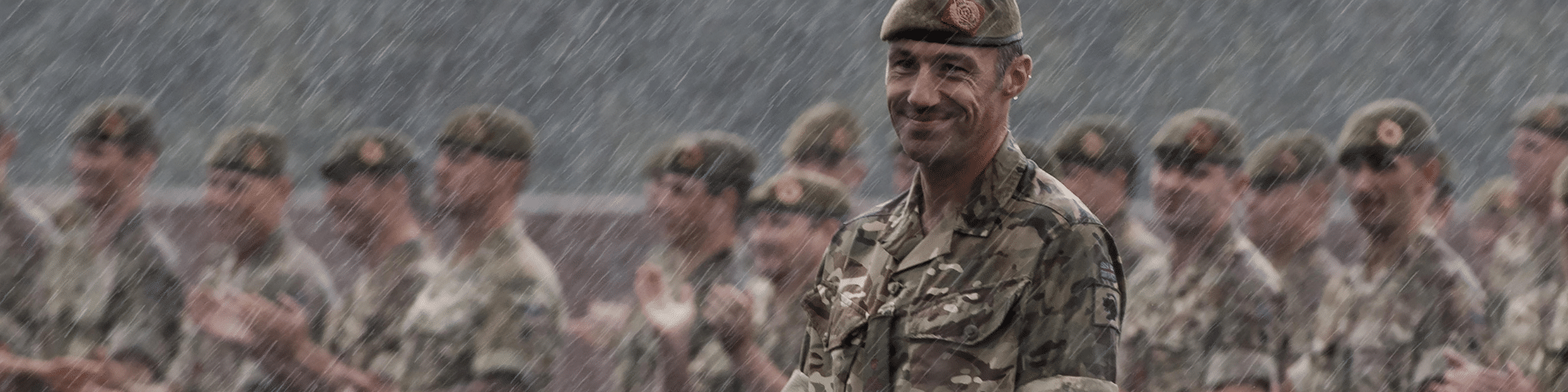 Soldiers smiling in rain
