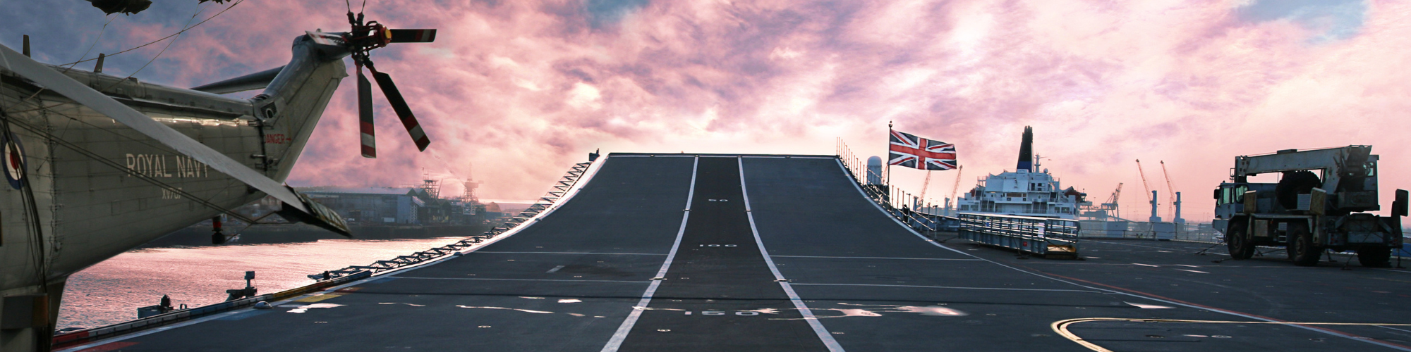 Image of a warship runway with pink sky