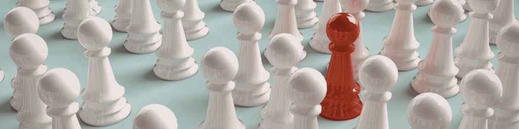 Red chess piece in sea of white