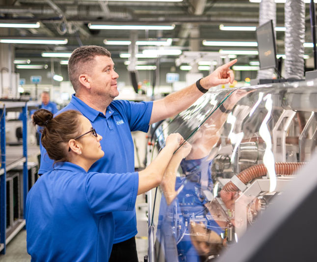 Male and female Elite employees working on a project at Elite Electronic Systems