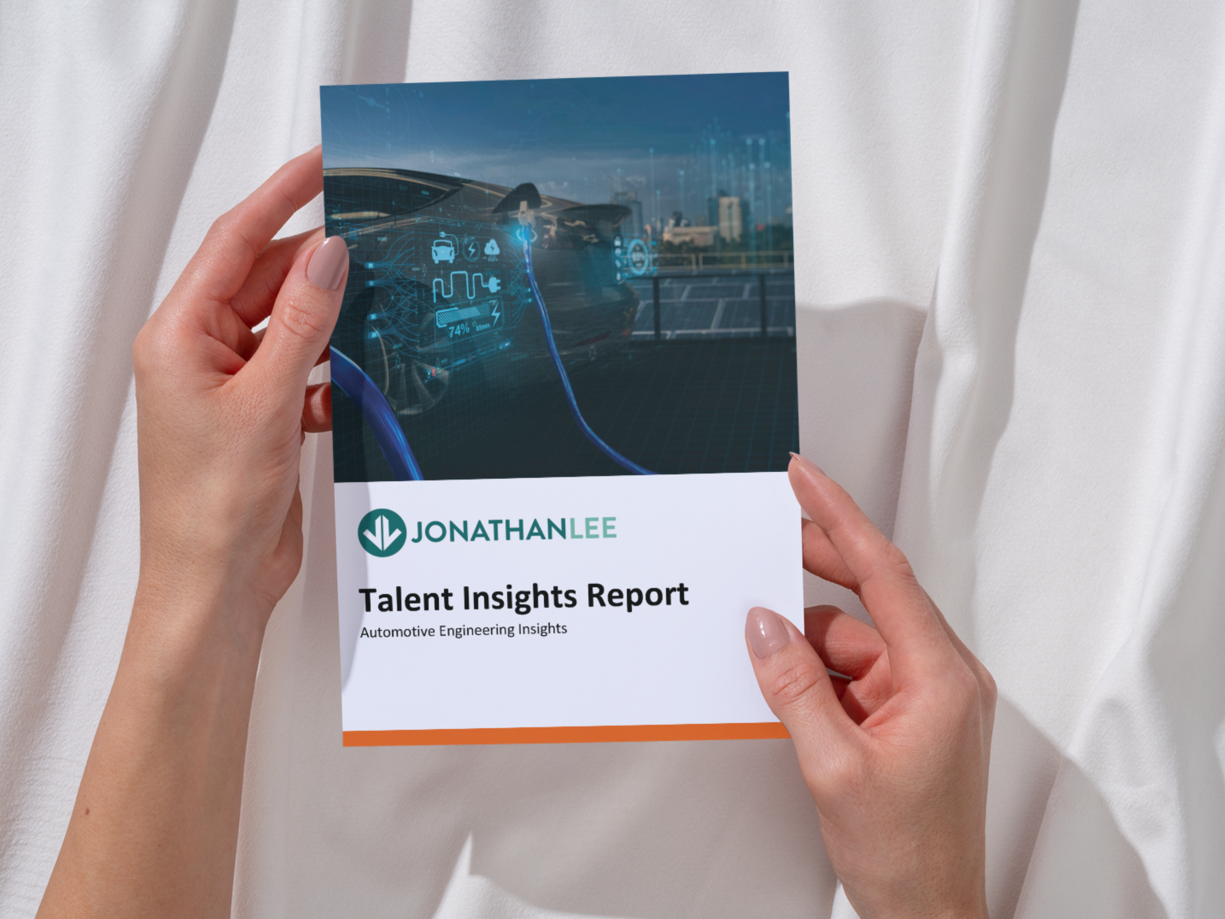 Hands holding up Jonathan Lee Recruitment's Automotive Engineering Talent Insights Report