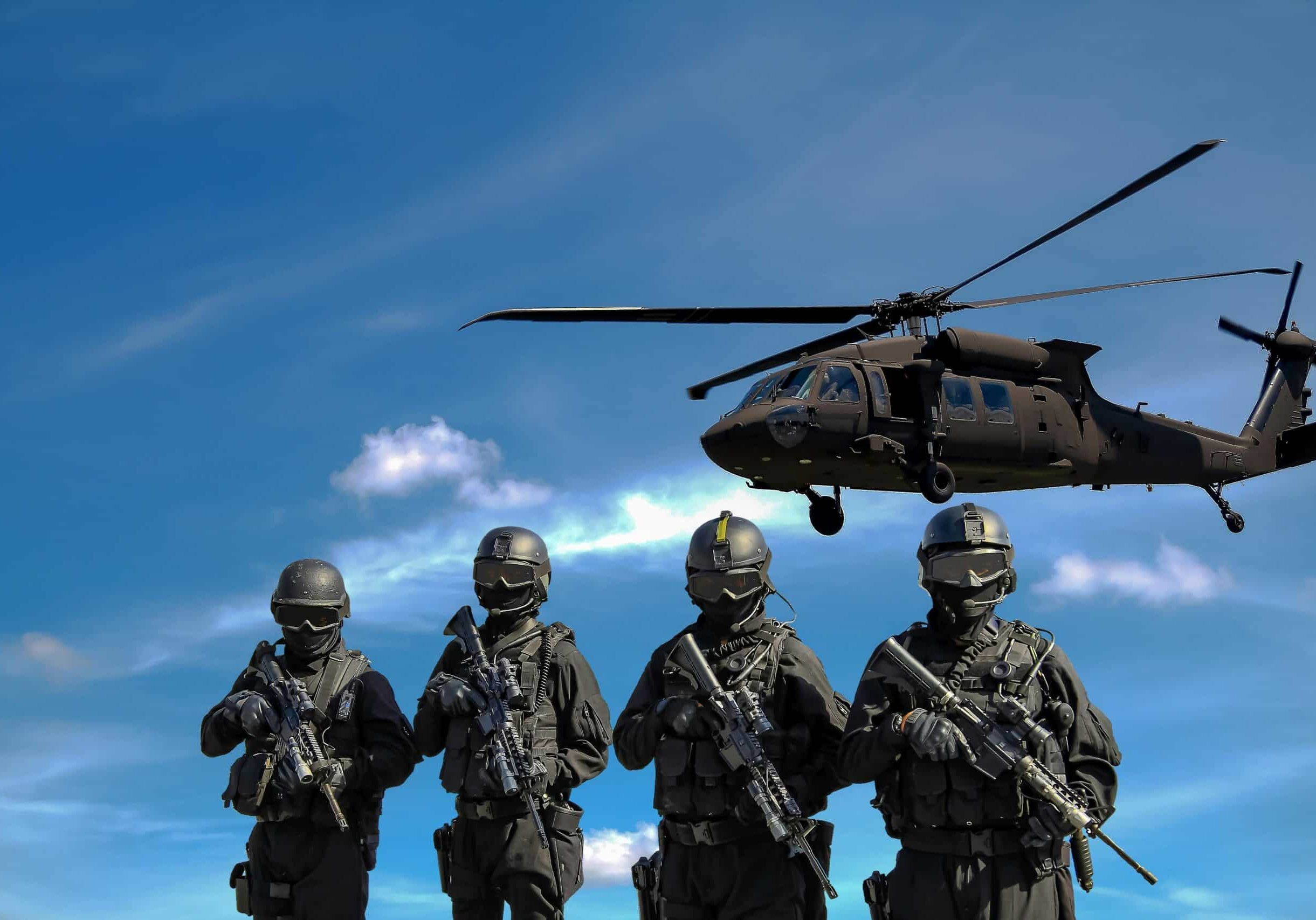 soldiers in front of helicopter